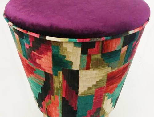 Small stool with colourful geometric upholstery