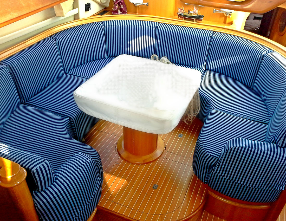 Custom striped marine upholstery fitted around a boat cabin